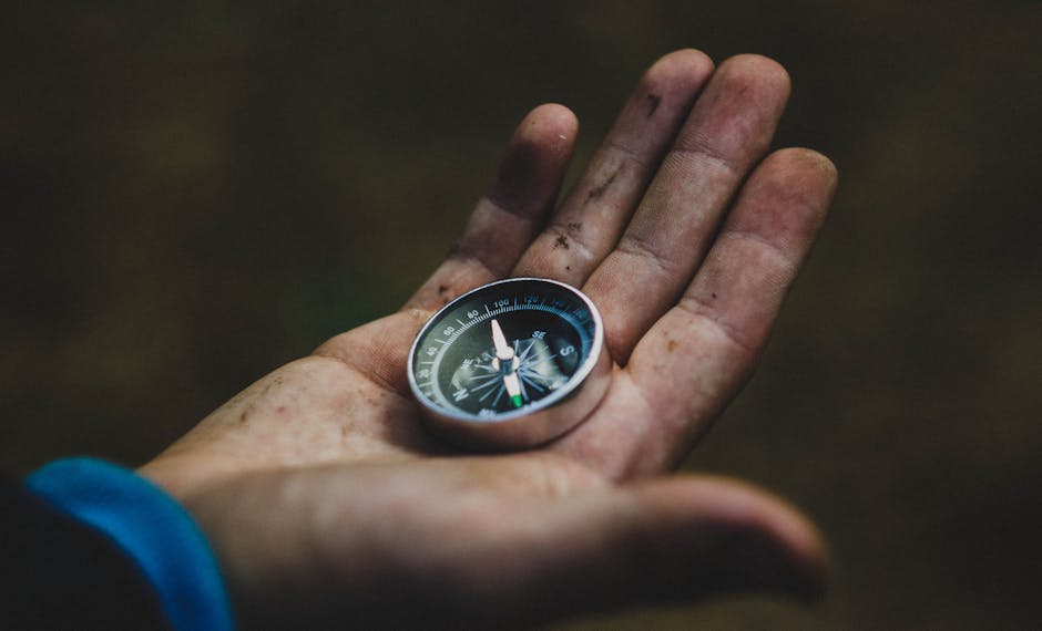 pexels-photo-220147-220147 A close-up of a compass held in a dirty hand, symbolizing adventure and navigation.