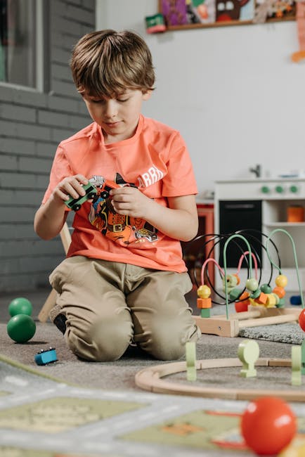 pexels-photo-8422251-8422251 Child playing with colorful toys in a cozy indoor playroom setting.