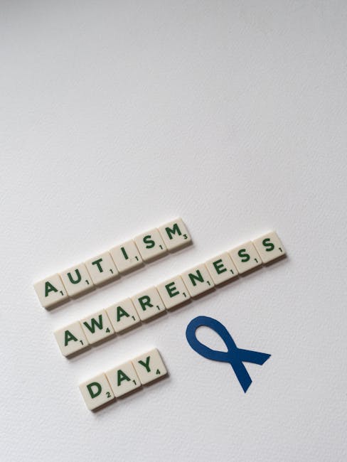 pexels-photo-8709258-8709258 Conceptual image featuring Scrabble tiles spelling out Autism Awareness Day with a blue ribbon.